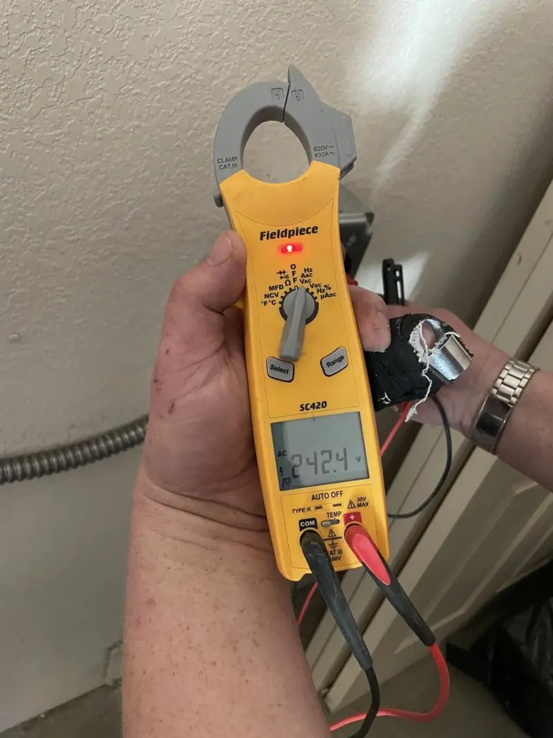 Voltage testing with clamp meter during Whole House Surge Protector in Manorhaven